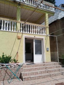 a house with stairs and a white door at гостевой дом Polina2 in Gornji Sušanj +4 photos