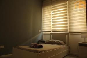 a bedroom with a bed with a window with blinds at CarloAlberto23- Rooms by Homes in Ancona in Ancona