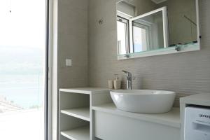 a bathroom with a sink and a mirror at Villa Le Grand Bleu in Đenovići +30 photos