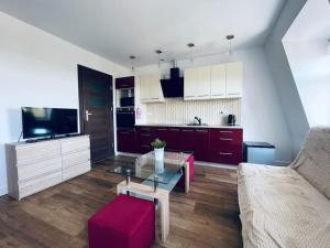 a living room with a couch and a glass table at EASY RENT- Wyszyńskiego, Centrum 24h Check-in in Lublin