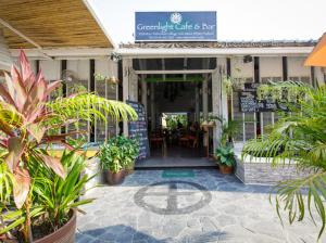 a patio with plants in front of a restaurant at Greenlight Fisherman's Village Resort & Café in Koh Samui 