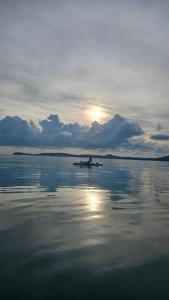 a person in a boat on the water at Greenlight Fisherman's Village Resort & Café in Koh Samui 