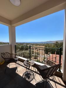 a balcony with chairs and a table and a view at Bella Vista in Karistos