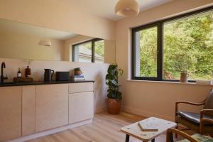 a kitchen with a counter and a window at Yarn - Honor Deluxe Suite in Ballycastle