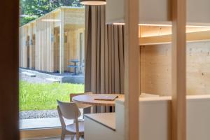 a room with a table and chairs and a window at Apartment am Camping Dornbirn - 212 Salzbödenkopf in Dornbirn