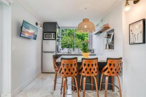 a kitchen with a table and four chairs at The Palms Coconut Grove 1 bedroom condo includes parking in Miami