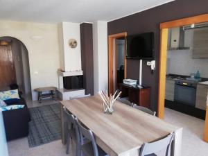 a living room with a dining table and a kitchen at La Casa di Giulia in Otranto