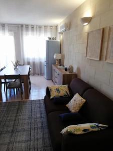 a living room with a couch and a kitchen at La Casa di Giulia in Otranto