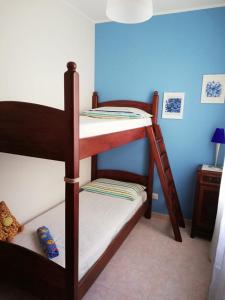two bunk beds in a room with a blue wall at La Casa di Giulia in Otranto +19 photos