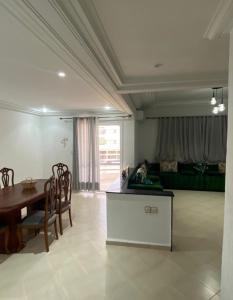 a living room with a table and a dining room at Résidence el fassi in Fès