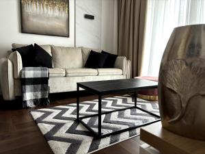 a living room with a couch and a table at Zlatibor Wayout, Spa & Wellness in Zlatibor