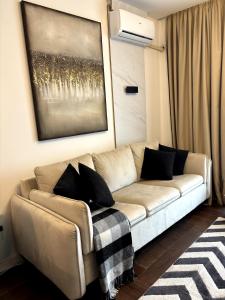 a living room with a couch and a painting on the wall at Zlatibor Wayout, Spa & Wellness in Zlatibor +36 photos