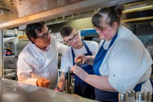 a group of three chefs working in a kitchen at AC Hotel by Marriott Belfast in Belfast +87 photos