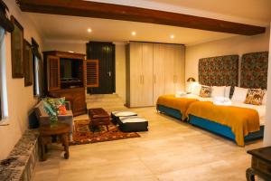 a large hotel room with a bed and a television at Zimbali Emerald Eden in Ballito +25 photos