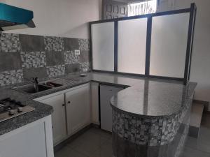 a kitchen with a sink and a counter top at appartement Cristiana 6 Midoun in Midoun
