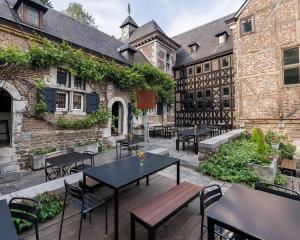 an outdoor patio with tables and chairs and a building at Loft 3 chambres "Bueren" - Parking - au centre de Liège by FineNest in Liège