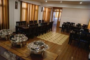 a dining room with a table and chairs and a table and chairsearcher at Jiwa lha Villa Ladakh by LexStays in Leh
