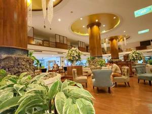 a lobby of a hotel with people sitting in chairs at 912 Good view &2 minutes walk to one Nimman Maya in Chiang Mai