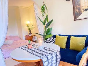 a living room with a blue couch and a table at 912 Good view &2 minutes walk to one Nimman Maya in Chiang Mai