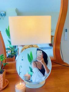 a woman taking a picture of herself in a mirror at 912 Good view &2 minutes walk to one Nimman Maya in Chiang Mai