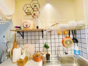 a kitchen with a sink and a tiled wall at 912 Good view &2 minutes walk to one Nimman Maya in Chiang Mai