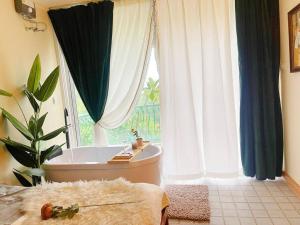 a bathroom with a tub and a large window at 912 Good view &2 minutes walk to one Nimman Maya in Chiang Mai