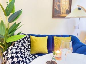 a blue couch with pillows and a table with a lamp at 912 Good view &2 minutes walk to one Nimman Maya in Chiang Mai