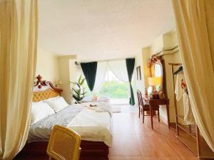 a bedroom with a bed and a desk and a window at 912 Good view &2 minutes walk to one Nimman Maya in Chiang Mai