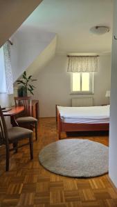 A bed or beds in a room at Guest House Pod Grebenom