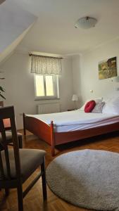 A bed or beds in a room at Guest House Pod Grebenom