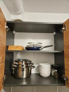a shelf with pots and pans in a kitchen at Ferienwohnung Lottstetten in Lottstetten