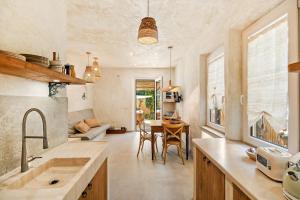 a kitchen and living room with a table and chairs at Fontarcella, Heart & Roots in Petrignano sul Lago