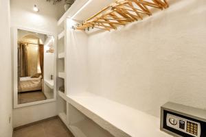 a bathroom with a mirror and a clock on a wall at Fontarcella, Heart & Roots in Petrignano sul Lago +86 photos