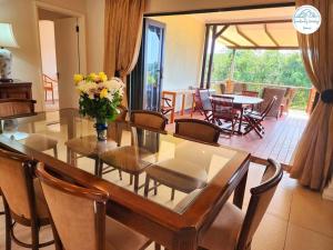 a dining room table with a vase of flowers on it at Villa P16 - Selborne Golf Estate in Pennington