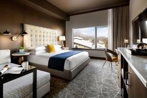 a hotel room with a bed and a kitchen at The Josie Hotel, Autograph Collection in Rossland