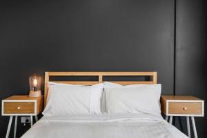 a bedroom with a bed with two nightstands and two white pillows at Brilliant 2BR Apartment in Belconnen - Hosted by Canstay in Belconnen +16 photos
