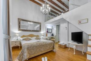 a bedroom with a bed and a flat screen tv at Palmotta Palace in Dubrovnik