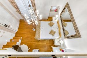 a living room with a chandelier and wooden floors at Palmotta Palace in Dubrovnik