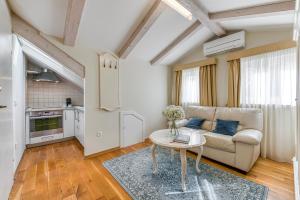 a living room with a couch and a table at Palmotta Palace in Dubrovnik