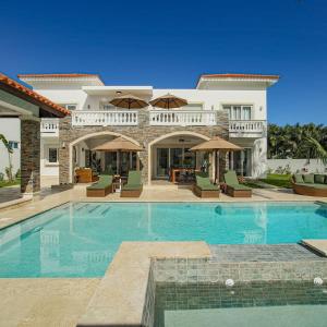 a villa with a swimming pool and a house at Royal 3 Bedroom Villa Lifestyle in San Felipe de Puerto Plata
