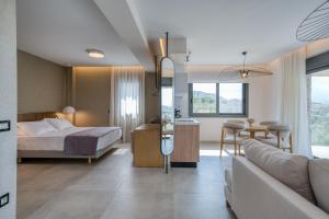 a hotel room with a bed and a living room at Doceo Refined Living in Nafplio +114 photos