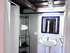 a white bathroom with a sink and a mirror at Sombrero de Pico C in El Paso +31 photos
