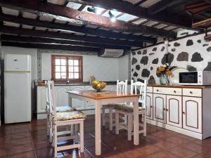 a kitchen with a table and chairs in a room at Sombrero de Pico C in El Paso