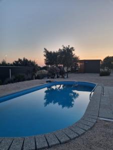 a large blue swimming pool in a yard at Mobile Home Elica, Pirovac in Pirovac