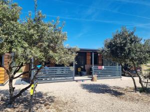 a house with trees in front of it at Mobile Home Elica, Pirovac in Pirovac