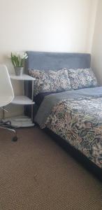 a bedroom with a bed and a chair and a table at Sweet Dreams in Luton +4 photos