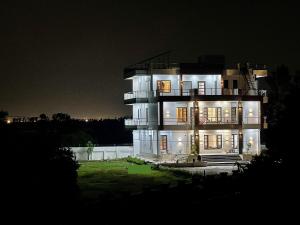 a large building with lights on at night at Vaidehi Resorts in Ayodhya
