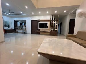 a living room with a couch and a tv at Vaidehi Resorts in Ayodhya +49 photos