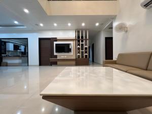 a living room with a couch and a tv at Vaidehi Resorts in Ayodhya