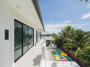 an exterior view of a house with a swimming pool at Milan Private Pool Villa Huahin in Hua Hin